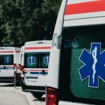 Três ambulâncias estacionadas ao ar livre, prontas para atendimentos de emergência.